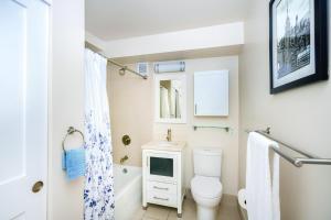 a bathroom with a toilet and a television in it at Elegant Upper East in New York