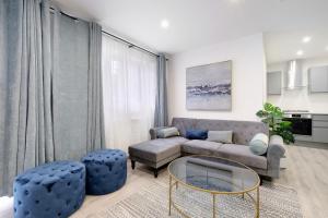 a living room with a couch and a table at Luxury Heathrow 1 & 2 Bedroom Apts, West Drayton Free parking By 360Stays in West Drayton