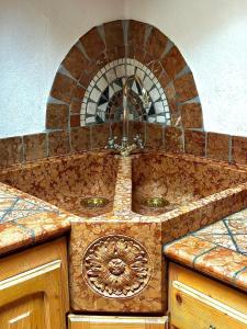 a kitchen counter with a sink and a mirror at Casa Gianmoena in Cavalese +24 photos