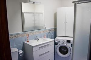 a bathroom with a sink and a washing machine at MI CAPRICHO in Santa Cruz de la Palma +3 photos