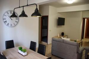 a living room with a table and a clock on the wall at MI CAPRICHO in Santa Cruz de la Palma