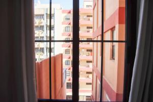a window with a view of a tall building at MI CAPRICHO in Santa Cruz de la Palma