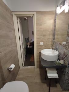 a bathroom with a sink and a toilet at Fabrizi in Catania