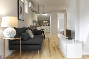 un soggiorno con divano grigio e una cucina di The Romantic Nest - the Perfect Getaway at Downtown, 6th-floor no lift a Lisbona