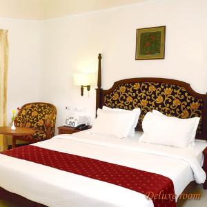 Łóżko lub łóżka w pokoju w obiekcie Hotel Grand Thekkady