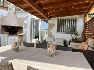 a table with two glass vases on a patio at Casa en primera linea de playa in Puzol