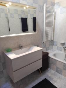 a bathroom with a sink and a tub and a mirror at casetta Vittorio in Mezzolago +13 photos