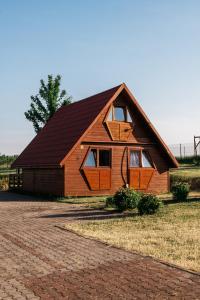 a large wooden house with a gambrel roof at Domki Bałtyckie in Władysławowo