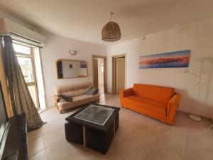 a living room with two couches and a coffee table at Belvedere Apartment in Sliema +4 photos