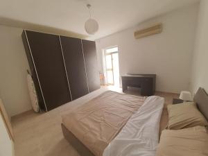 a bedroom with a large bed and a desk at Belvedere Apartment in Sliema
