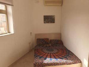 a small bedroom with a bed and a window at Belvedere Apartment in Sliema