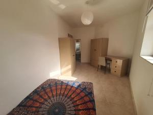 a bedroom with a bed and a desk in a room at Belvedere Apartment in Sliema