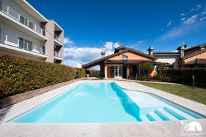 a swimming pool in front of a house at Villa San Martino in San Martino della Battaglia