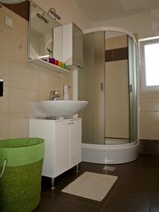 a bathroom with a sink and a shower at Apartment Roxy in Zadar