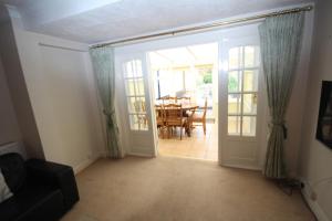 an open door to a dining room with a table at The Ruislip Bungalow in Ruislip