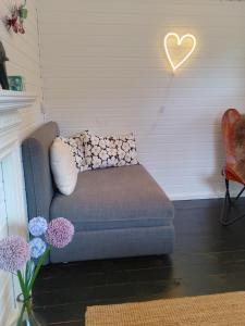 a couch in a living room with a heart on the wall at J in Kreuztal
