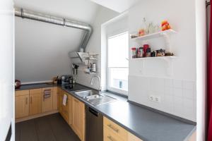 a kitchen with a sink and a counter top at The Beverly Hills of Frankfurt in Hofheim Penthouse or Garden in Hofheim am Taunus