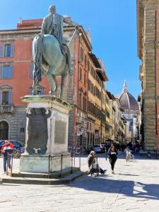 a statue of a man on a horse in a street at B&B i Rinascimenti in Florence