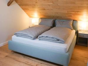 a bed in a room with two pillows on it at Ferienhaus Altstadtchalet in Schmallenberg