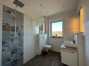 a bathroom with a sink and a toilet and a shower at Moin Moin in Wildeshausen +29 photos