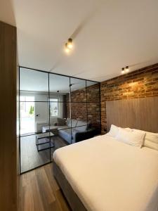 a bedroom with a large bed and a glass wall at Anja & Ogo apartments with Pool _ in Petrovac na Moru