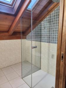 a glass shower in a room with a ceiling at Saint James Way in Cacabelos