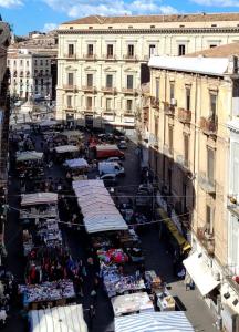 an open air market in a city with buildings at Th Luxury Central in Catania