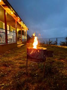 a table with a fire in front of a building at Trabzon Mountain House-UZUNLU in Trabzon