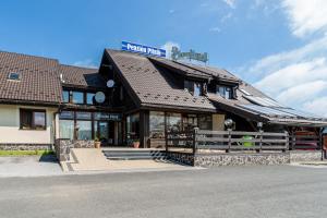 a building with a sign on top of it at Penzión Pltník in Červený Kláštor