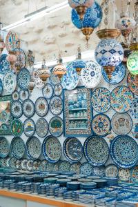 a display of blue and white plates and bowls at Kubler's House - By Beach Apartments TLV in Tel Aviv