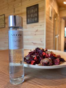 a bottle of water next to a plate of food at The Green Man, Eco-friendly cabin in the Lincolnshire countryside with heating and hot water in Lincoln