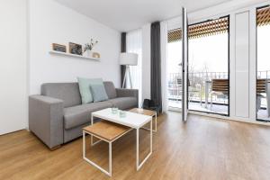 a living room with a couch and a table at Ferienwohnung Ankergold im Deichhaus in Bensersiel