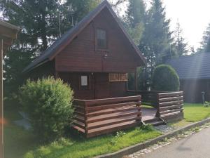a small cabin with a fence in front of it at Hotel Pavla Vysočina in Nové Město na Moravě