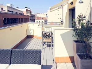 a balcony with chairs and plants on a building at Mercure Madrid Centro in Madrid