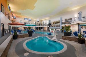 a pool at a hotel with a swimming pool at Revel Hotel Minot - SureStay Collection by Best Western in Minot