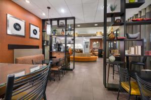 a restaurant with tables and chairs and a lobby at Revel Hotel Minot - SureStay Collection by Best Western in Minot
