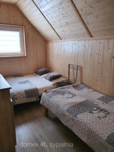 a room with two beds and a window at siodemkacamp in Łeba