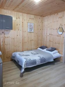 a bedroom with a bed and a flat screen tv at siodemkacamp in Łeba