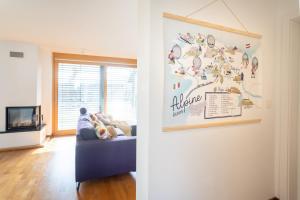 a living room with a blue couch and a wall at Home Away From Home in Radovljica