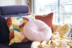 a pillow sitting on a couch with colorful pillows at Home Away From Home in Radovljica +46 photos