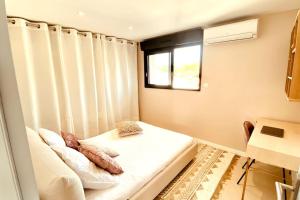 a small room with a bed and a window at Romy YourHostHelper in Saint-Cyr-sur-Mer