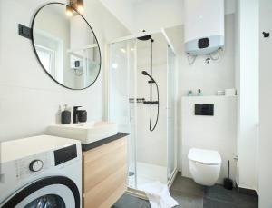 a bathroom with a washing machine and a sink at Cali & Rio Apartments by Irundo in Zagreb