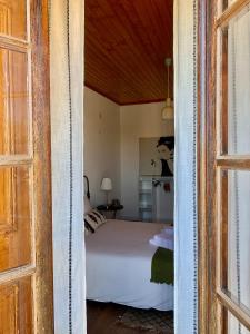a view of a bedroom with a bed through a door at Casa do Rossio in Estremoz