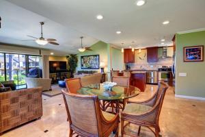 a dining room and living room with a table and chairs at WAILEA ELUA, #1204 condo in Wailea +29 photos