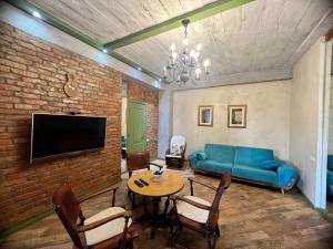 a living room with a blue couch and a table at T2&T3 Apartments LEVANTO in Tbilisi City