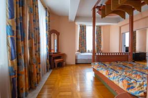 a bedroom with a canopy bed in a room at Hotel Slaviani in Dimitrovgrad