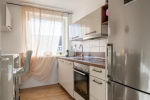 a kitchen with a stainless steel refrigerator and a window at Private Apartment in Lehrte