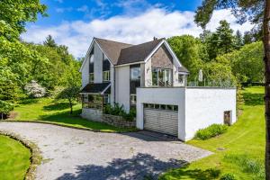 a house with a driveway and a garage at Bells View in Kippford
