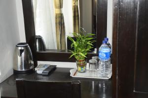 a table with a remote control and water bottles on it at twin bedroom in Thamel- 850 meters from Kathmandu durbar square in Kathmandu