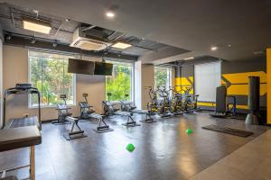 a gym with several treadmills and exercise bikes at Cozrum Homes - Sonata Residence in Ho Chi Minh City